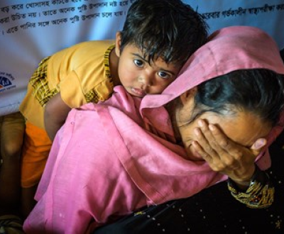 A women hiding her face with a child 