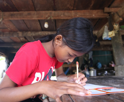 13 year old Ny from Cambodia writes cards for her sponsor