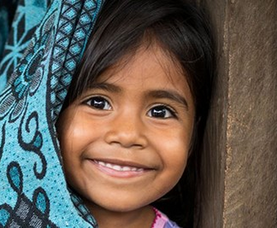 Little girl smiling towards the camera