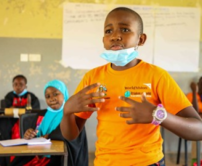 Boy from Uganda speaking out in the local children's parliament