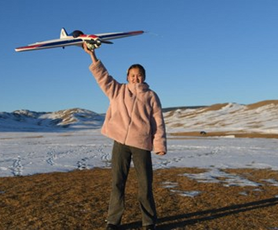 16 years old sponsored child Nomin from Mongolia holding Model Aircraft.