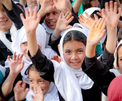 Children in Afghanistan raise hands