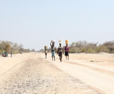 People line up for hours, sometimes all day, to collect water from a borehole in Angola