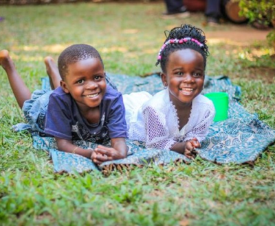 Kids lying on a mat in a ground