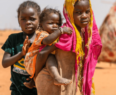 A girl carrying a baby in her back