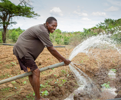 A farmer, from the Vision farming group, works in the fields in Marafa AP, Kenya