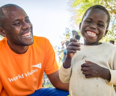 A boy with world vision staff