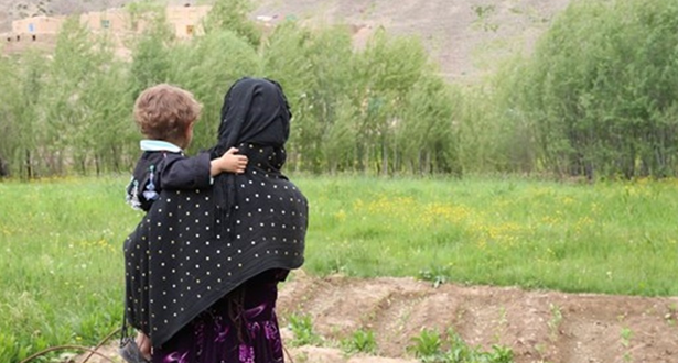 A woman carrying a child in Afghanistan