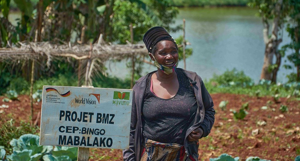 Farmer Chantal smiling in front of her cabbage farm field.