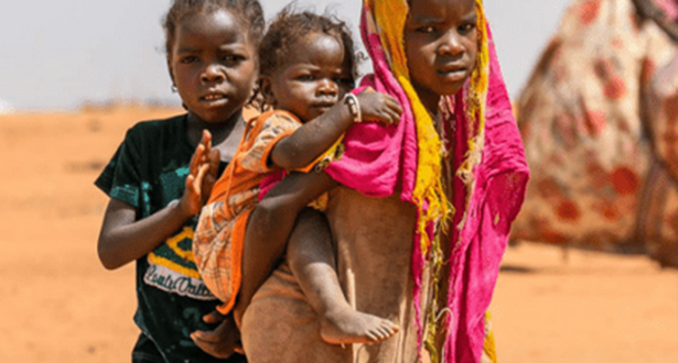 A girl carrying a baby in her back