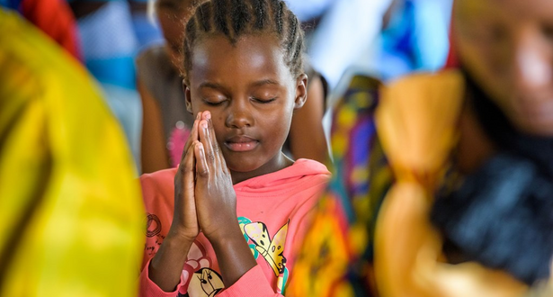 A girl from Kalawa AP, Kenya, praying