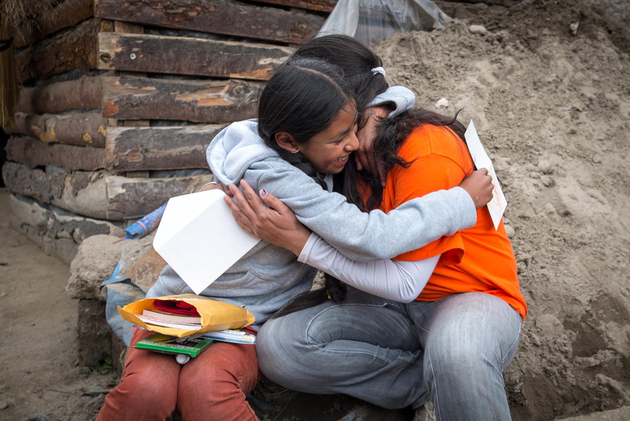 11 years old Rocio from Bolivia receives a package from her sponsor, through a World Vision staff