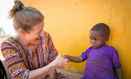 A World Vision ambassador pays visit to a sponsored child in Tanzania