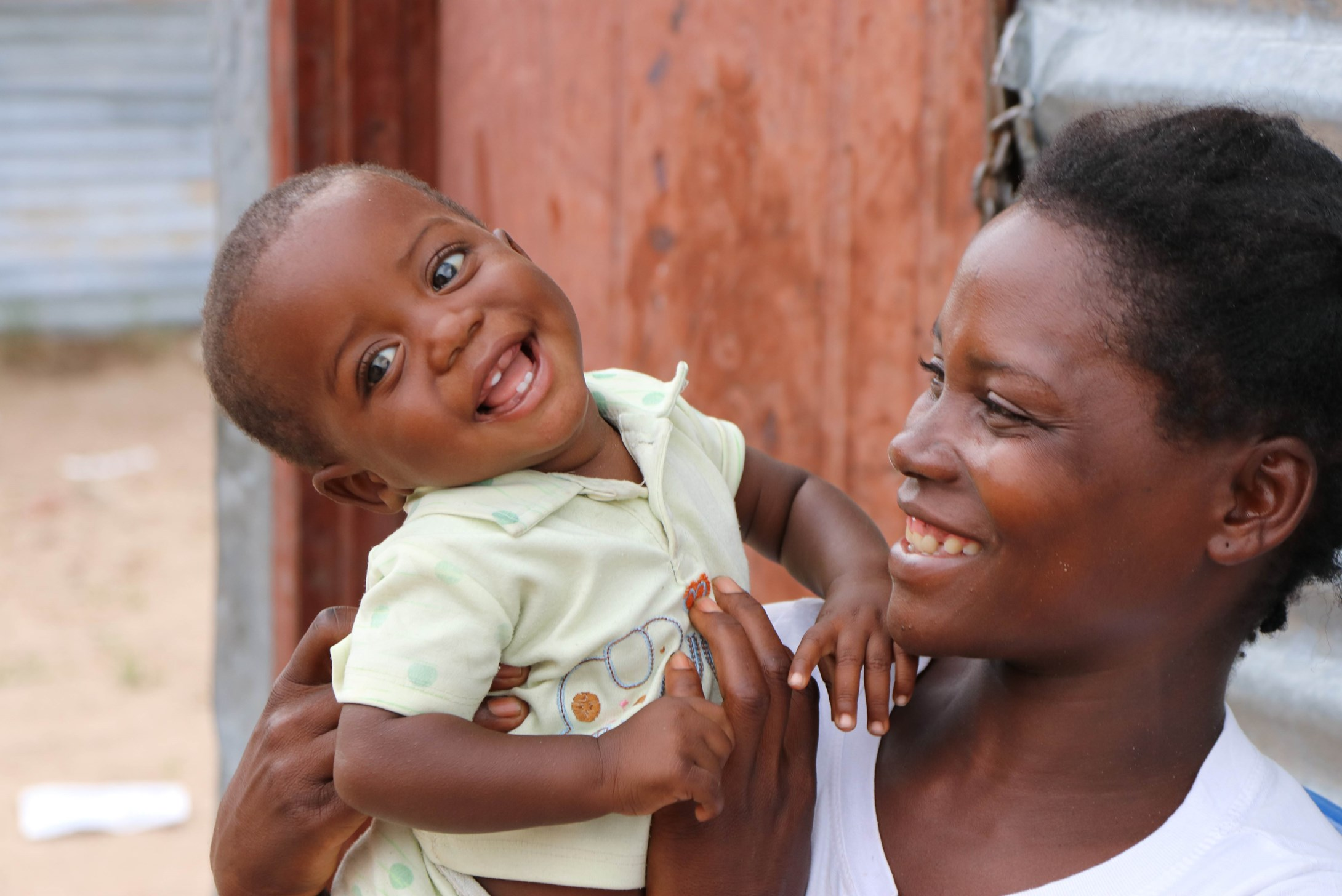 A mother holding a one-year-old boy in Angola