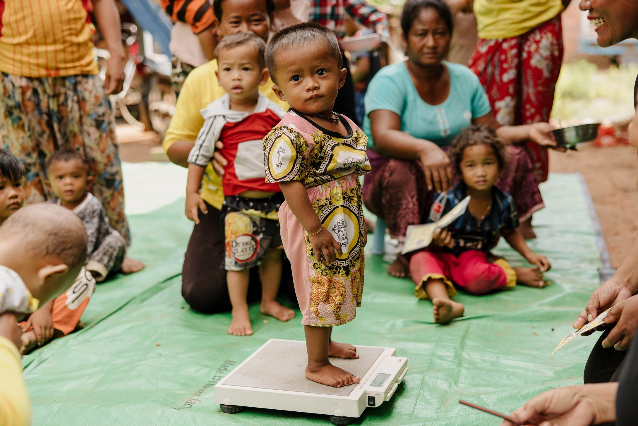 A young boy getting his weight checked at a Village Health Group in Cambodia.