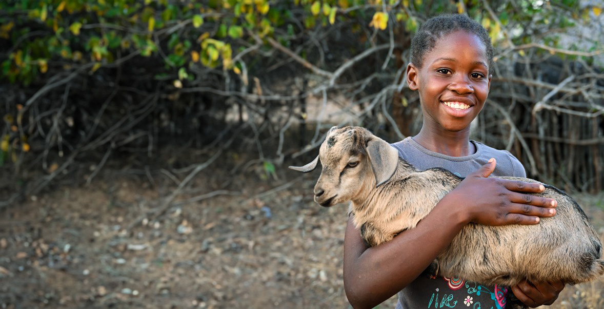 girl holding a goat