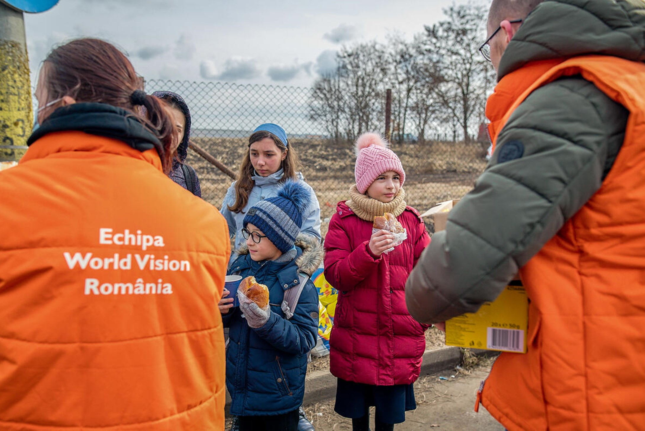 WV Romania staff members Nicoleta Popa and Alberto Roca with Ukrainians on the border with Romania called Vama siret.