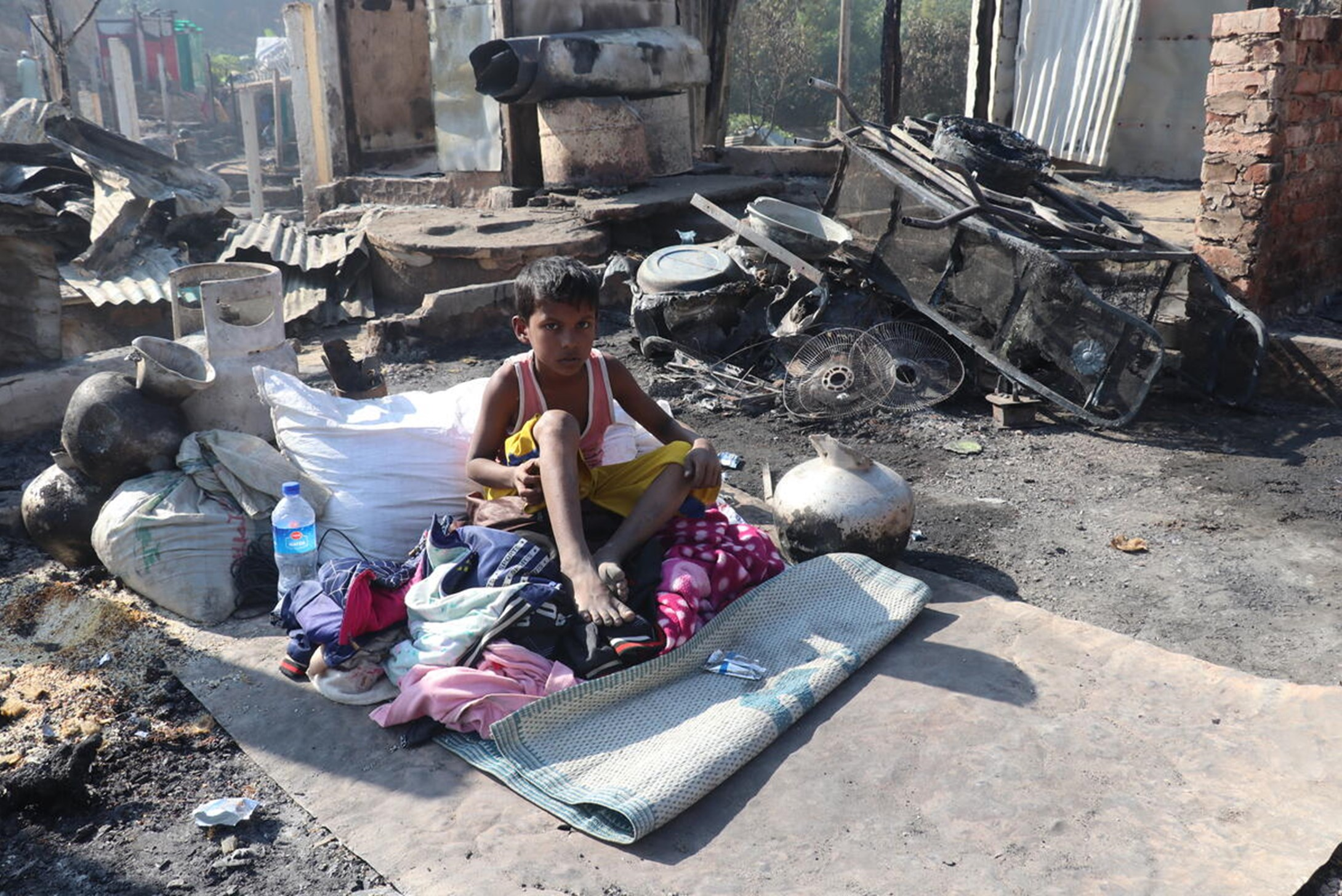 A refugee boy sitting helplessly after a significant fire swept in Cox’s Bazar, impacting thousands of Rohingya refugees and host community members.